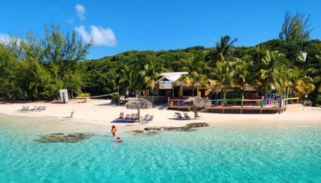 Drone image of Footprints Bar on Rose Island with palm trees, beautiful white sand beach, turquoise water, Caribbean colors.